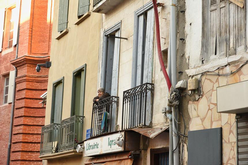 A Gypsy woman on the balcony of her home in St. Jacques. Her home was deemed unsafe and was taken down.