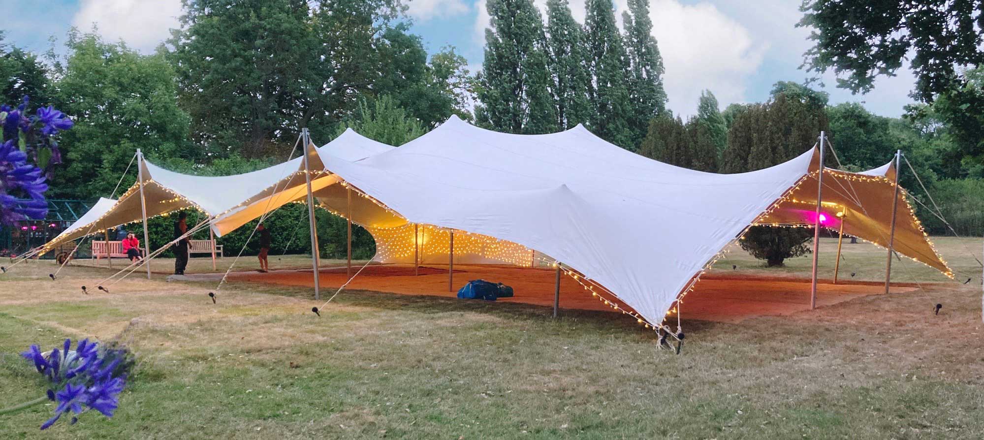 Big wedding tent on a lawn.