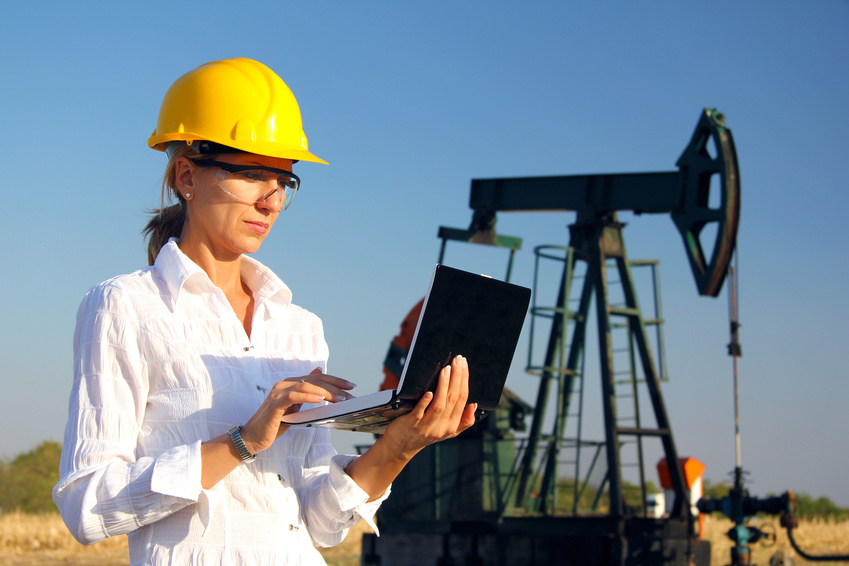 Female engineer in an oilfield working with notebook