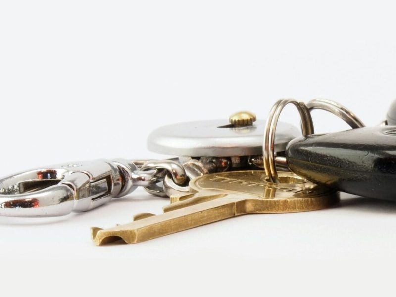 pexels-photo-842528-842528 Detailed image of car keys on a white surface, including a key fob and keychain.