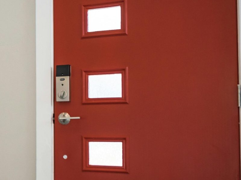 pexels-photo-922796-922796 Contemporary interior with a vibrant red entrance door and stairs, showcasing minimalist design.