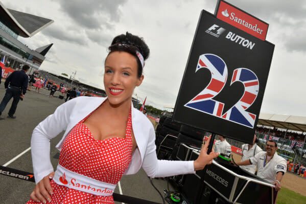 formula 1 gird girl holding jenson button team flag