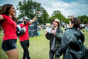 all points east festival staff distributing promotional branded caps