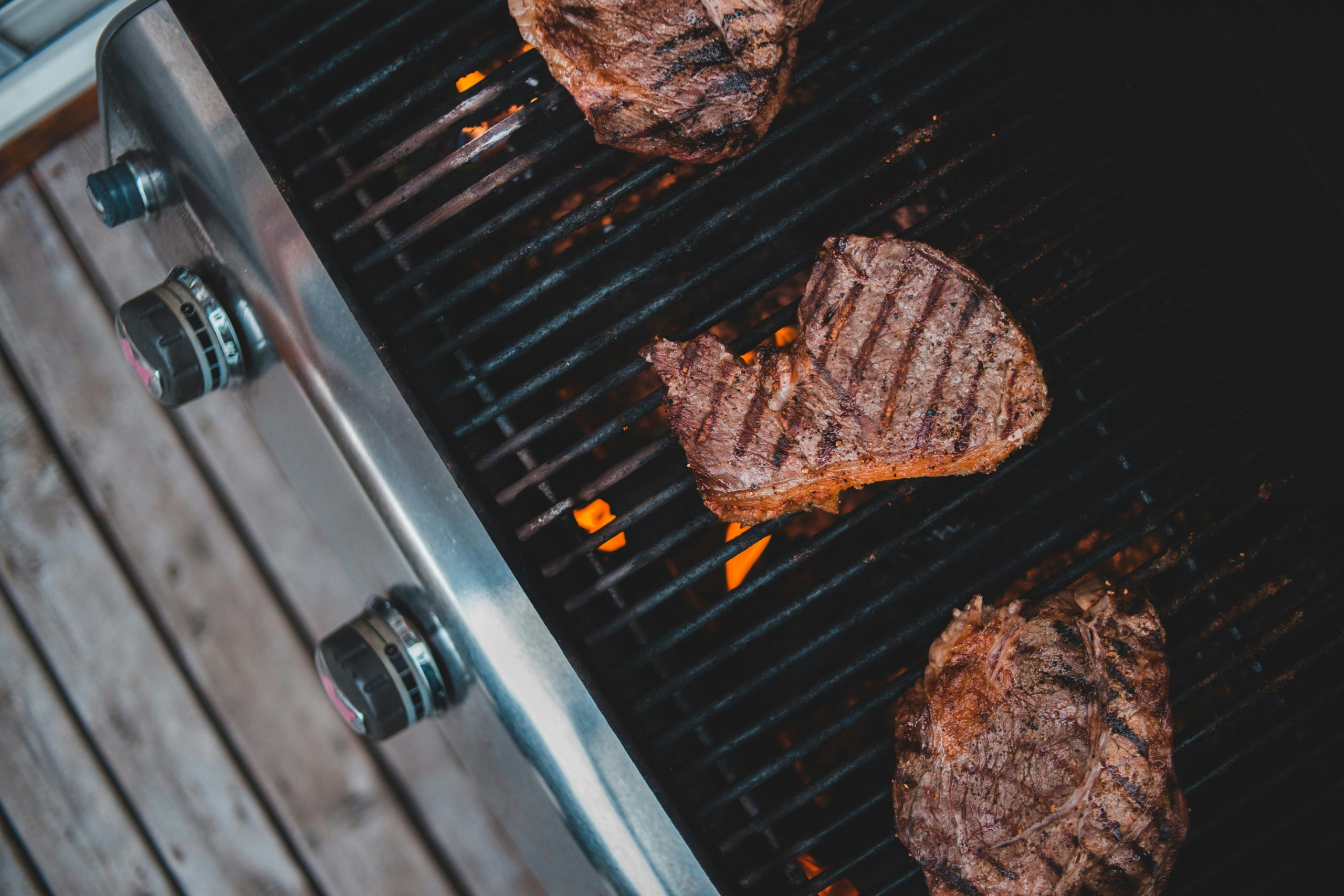 https://www.pexels.com/photo/meat-frying-on-grill-in-yard-4061451/