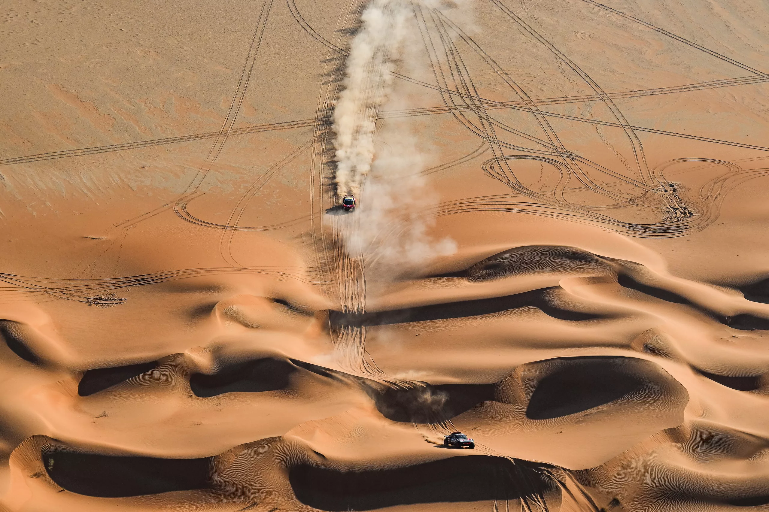 Sébastien Loeb and Fabian Lurquin on their Prodrive BRX Hunter T1+ of the Bahrain Raid Xtreme following Carlos Sainz and Lucas Cruz on their Audi RS Q e-tron E2 of the Team Audi Sport during the Stage 6 « 48 Hours Chrono » of the Dakar 2024 from January 11 to 12, 2024 around Subaytah, Saudi Arabia // Red Bull Content Pool //