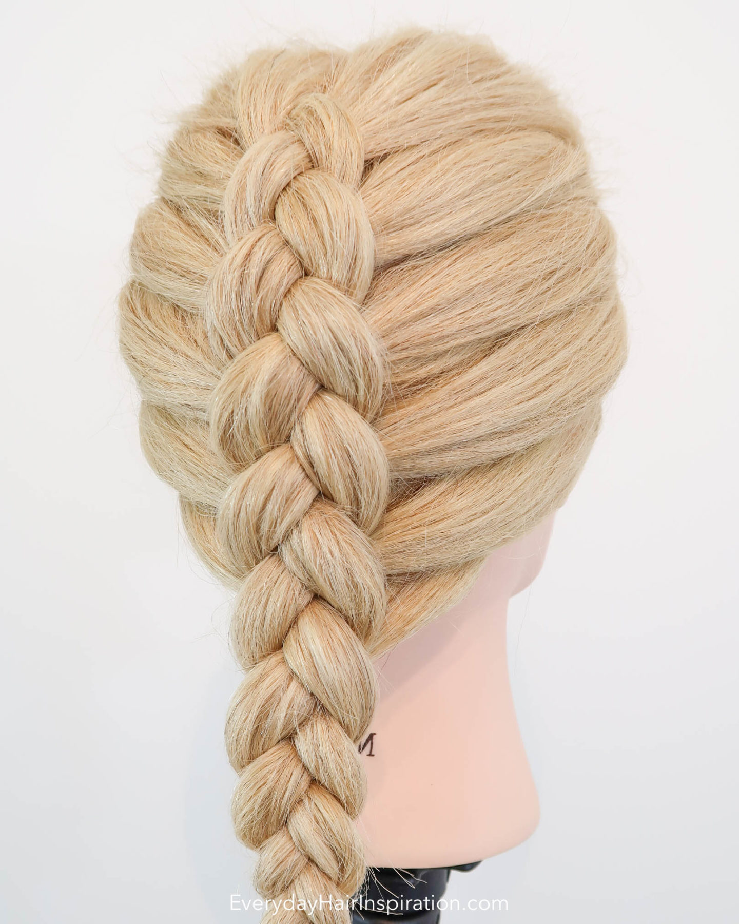 Blonde hairdresser doll with a single dutch braid down the back of the head