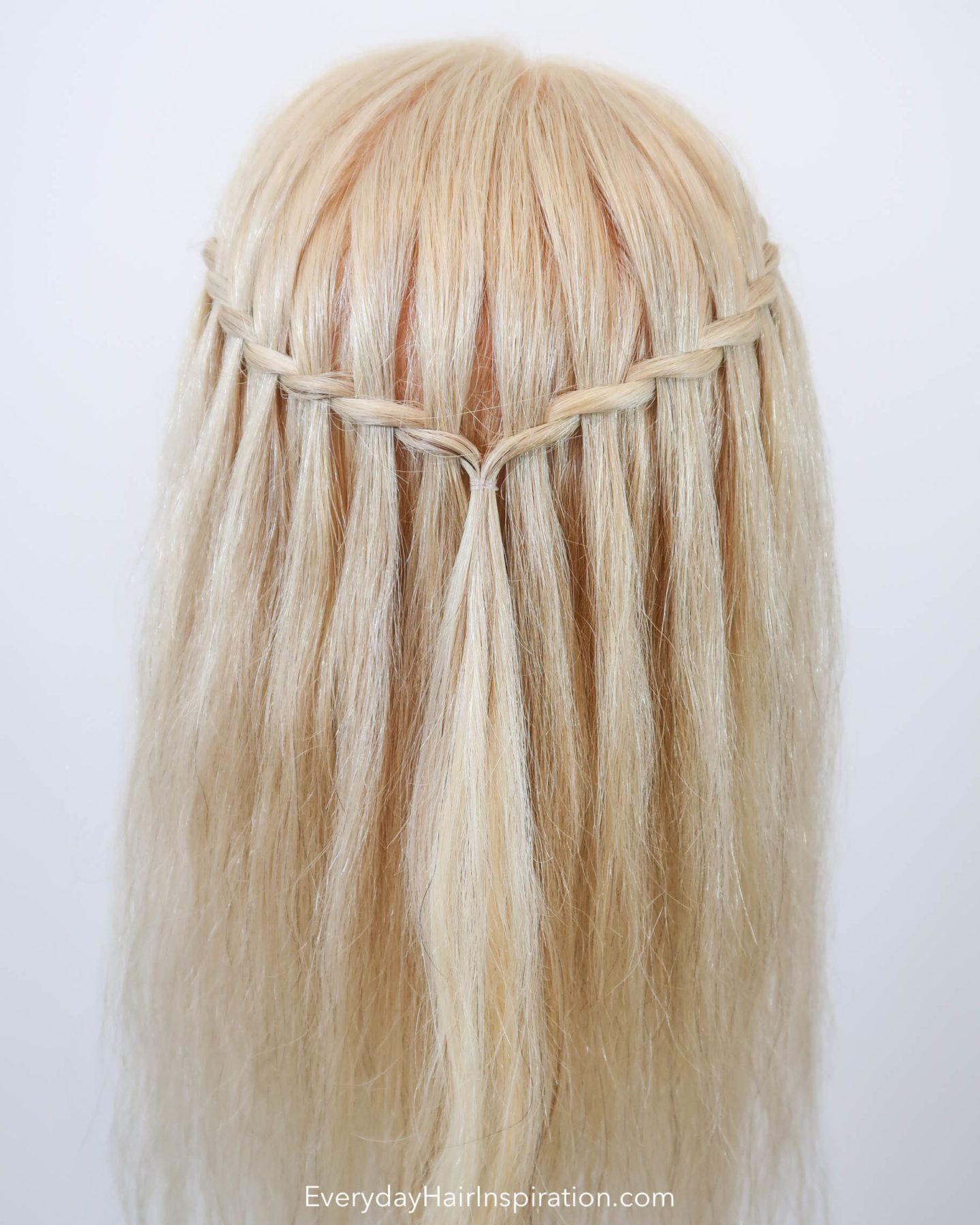 Blonde Hairdresser doll with a twisted waterfall braid in the hair, seen from the back.