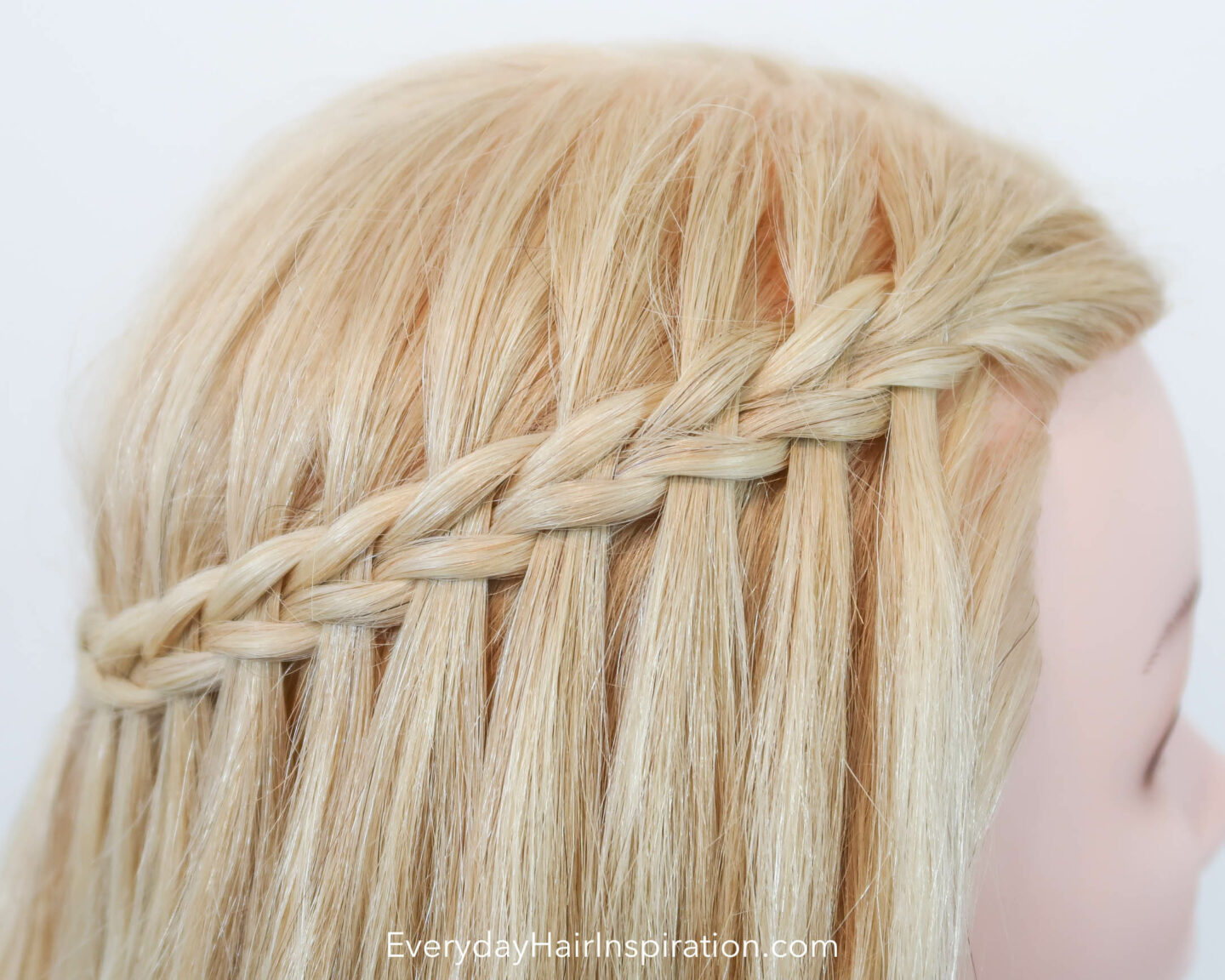 Close up of blonde hair with a scissor water fall braid. 