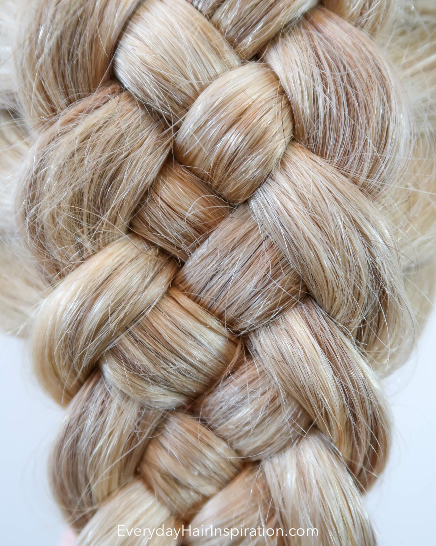 Blonde hairdresser doll with the hair styled into a dutch 5 strand braid, close up of the braid.