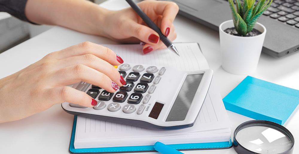 Tax time concept with wooden blocks and coins on white backgroun