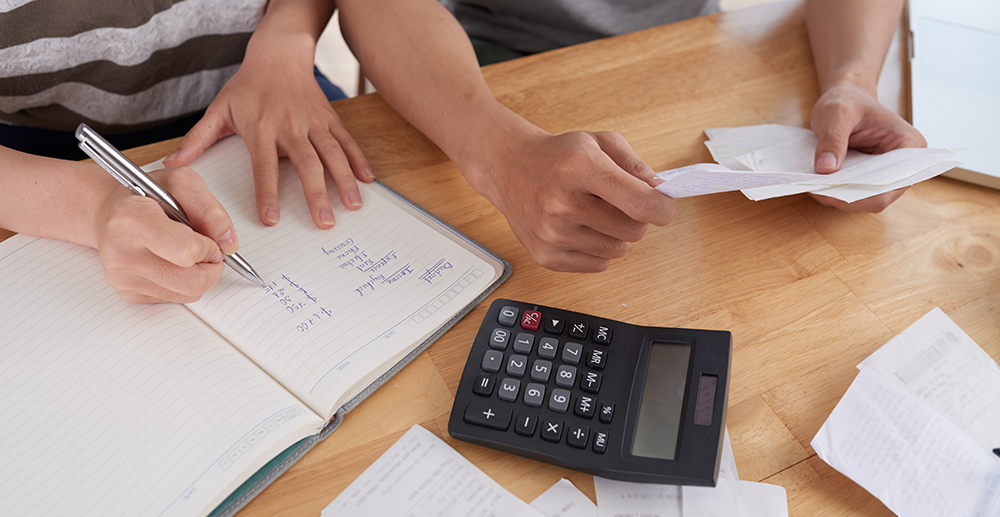 Tax time concept with wooden blocks and coins on white backgroun