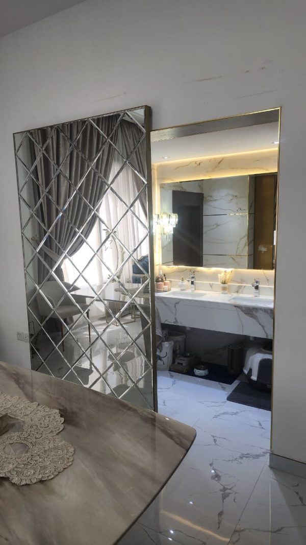 Gold Concealed sliding magic door with full-length mirror installed in Dubai and Abu Dhabi luxury homes, popular for kitchens and bathrooms