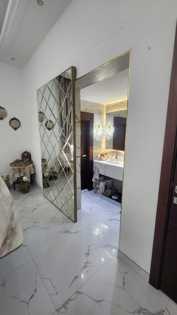 Gold Concealed sliding magic door with full-length mirror installed in Dubai and Abu Dhabi luxury homes, popular for kitchens and bathrooms
