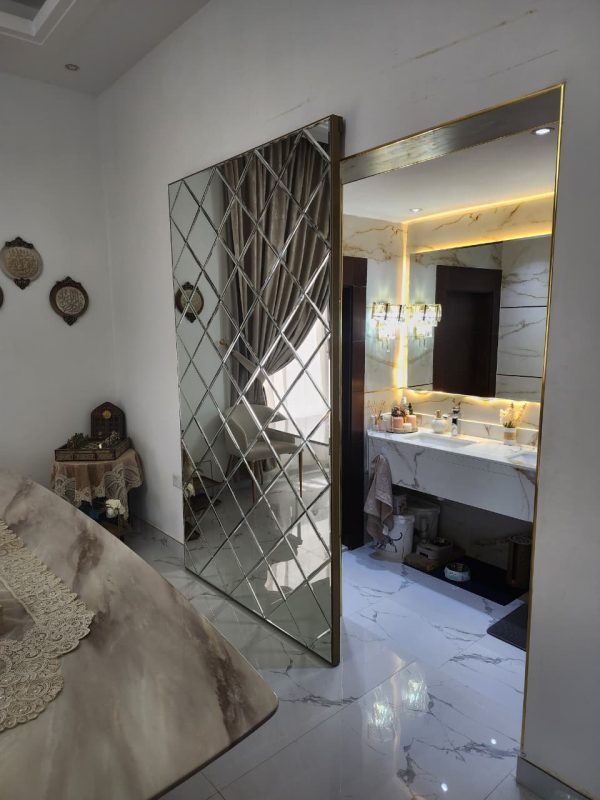 Gold Concealed sliding magic door with full-length mirror installed in Dubai and Abu Dhabi luxury homes, popular for kitchens and bathrooms