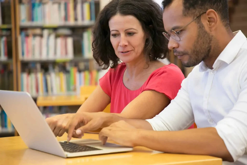 people studying with laptop together