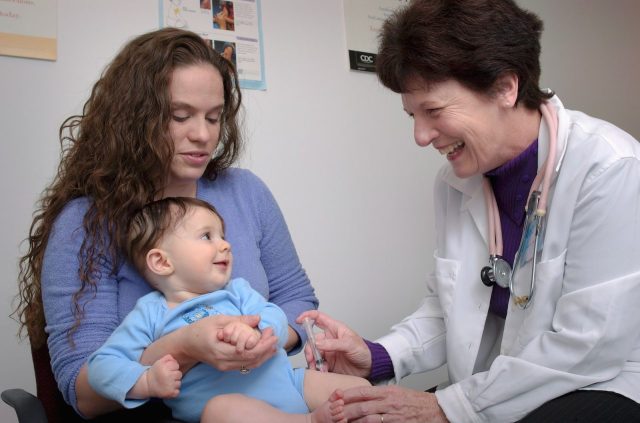 a young child is being examined by a doctor