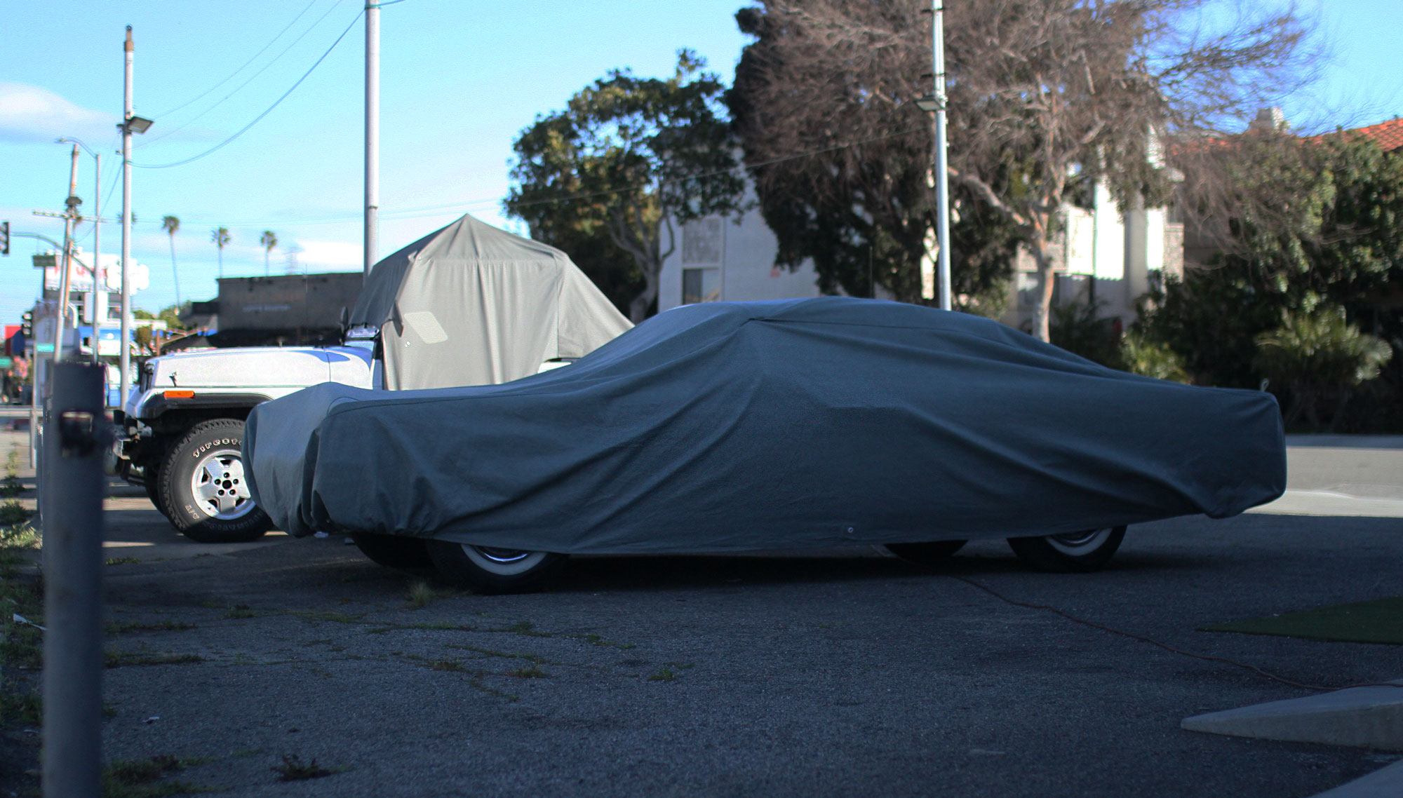 Lincoln Continental under the cover outside Garage 77