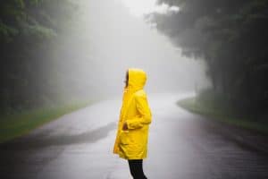 person holding in yellow rain coat