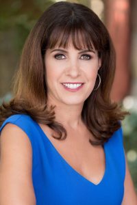 Brunette Woman Smiling in Blue Dress