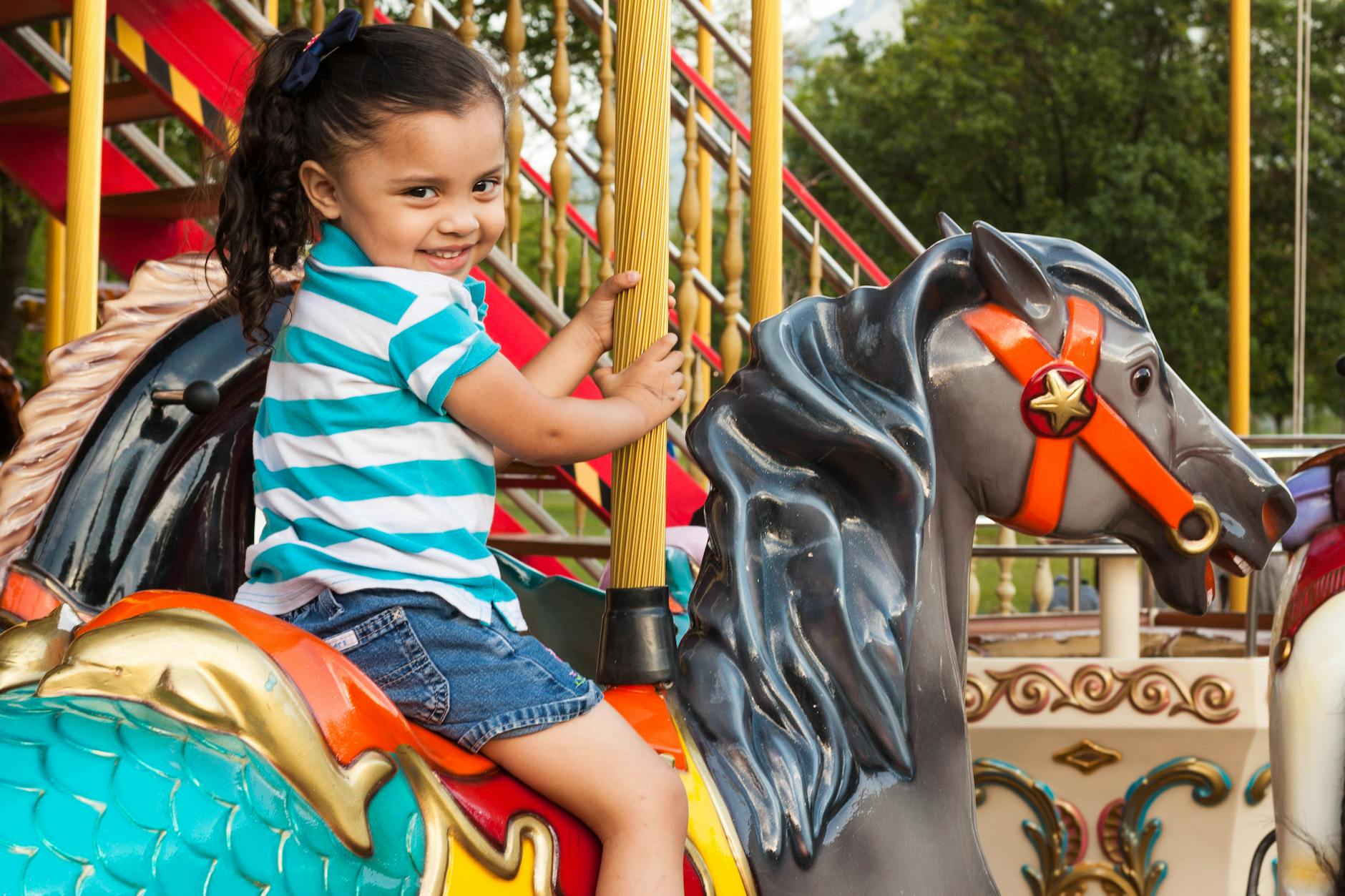 girl riding carousel
