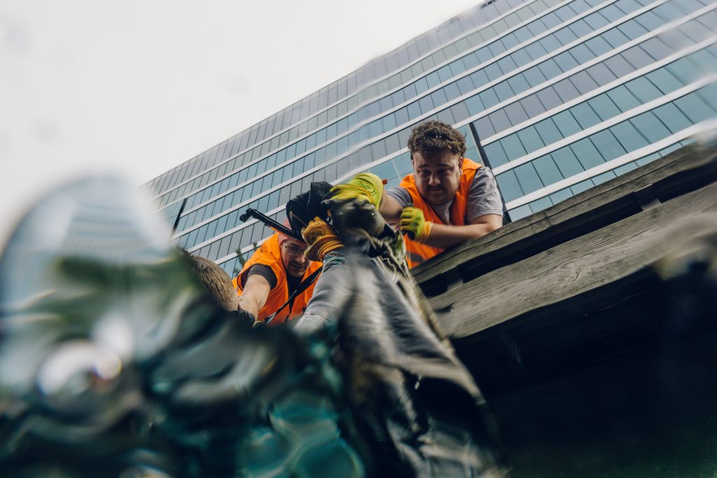 Fjord CleanUP cleaning rubbish out of the Akerselva river in Bjørvika beside Barcode Oslo