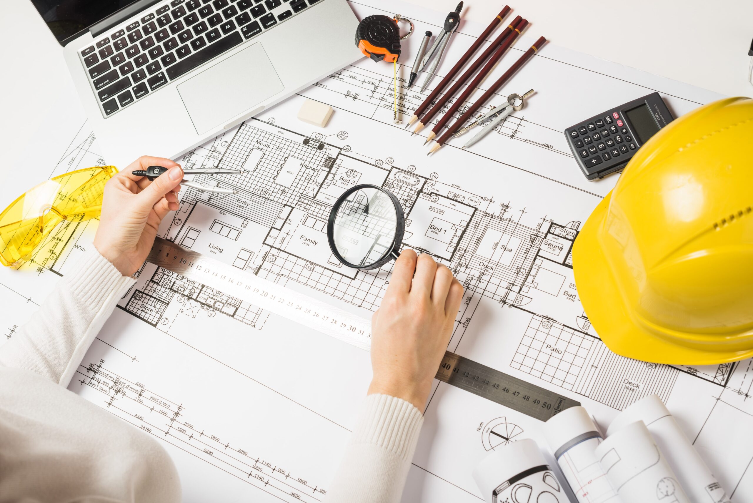 architect making plan with loupe min scaled