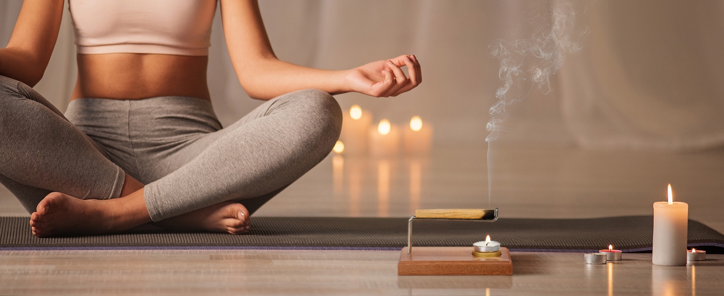 During meditation, lit sacred wood and candles are placed on sacred wood holders to burn