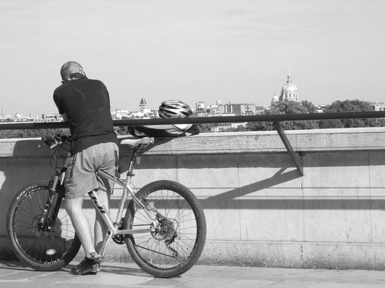 "I come to this bridge every day and wonder about ending it all. Why am I contemplating suicide?Well, look at me…. I’m bald! I know from the back it just looks shaved, but at the front, it’s like a helicopter view of refugees scattering and fleeing border patrol.It sounds vain, I know, but it causes me misery.Also, to rub further salt into my scalp, my girlfriend left me. She told me it wasn’t about my hair loss, but she left me for a hair model. I’ve seen pictures of him and her together on Facebook and his hair looks like the hair I used to have atop my head. Don’t tell me my follicle shortage had nothing to do with her leaving me!When we first met, I had a luxurious head of hair. Women always complimented me on it. It’s what she found attractive about me. I promised her when we first got together, I would never go bald. I guess I broke that promise.  Oh, why did I have to go bald? What did I do to deserve this, lord? I keep asking again and again.  The only possible reason that comes to my mind is when I would, at night, sneak into people’s chicken coops and pluck their chickens bald. I’d hide out till the morning and wait to see the look on the owner’s face. Man, that was great fun! But there’s no such thing as poetic justice…. is there?   I’ve tried everything to get my hair back. But no matter how far I cycle, my hair just won’t grow back.Every day, I motion like I’m going to jump off. I place my helmet down on the rail because committing suicide with your helmet still on, while allegedly safer, makes you look way uncool. After my helmet is resting safely, I then put one foot on the rail and hold that position to look like I’m climbing up and over. And then, I wait for somebody to notice and intervene. Nobody has ever tried to stop me. Not once.And you know why they don’t?Probably because I’m bald and not worth saving."