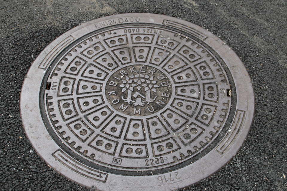 Канализационный люк коммуны Биркерёд с изображением старого герба. Фото 8 июля 2021