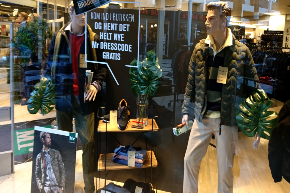 Листья монстеры деликатесной в оформлении витрины магазина мужской одежды