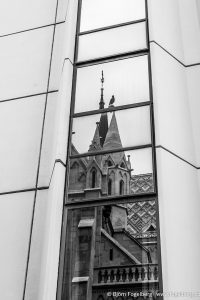 The reflection of a towering building