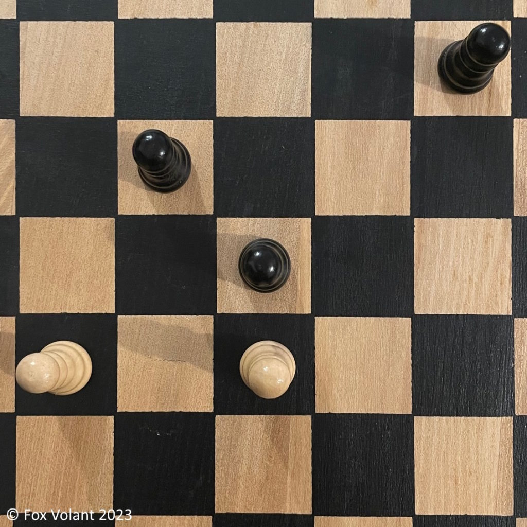 Close up of a chess board showing the perspective of the pieces.