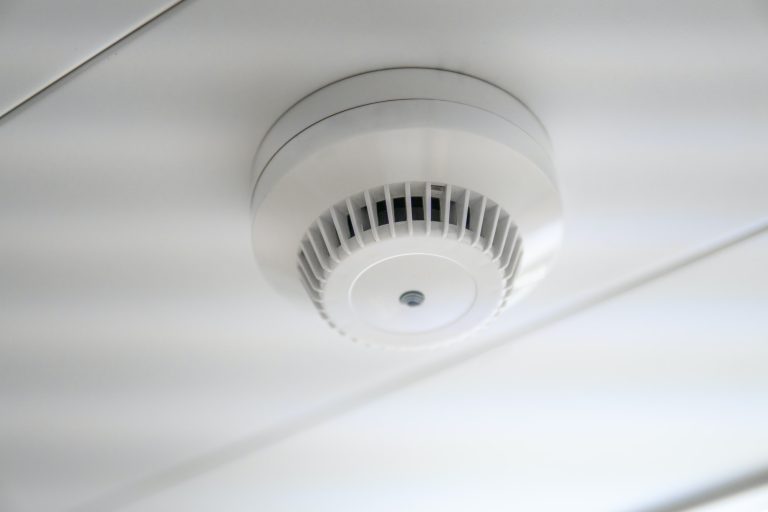 smoke detector and fire sensor on a ceiling