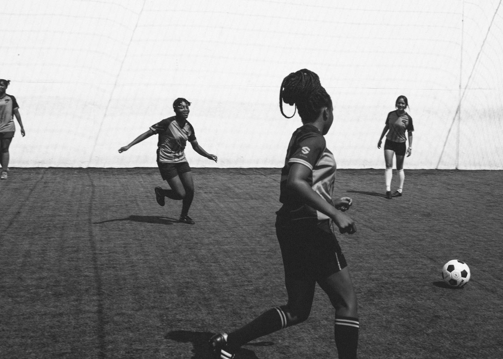Female football team cheerfully playing in football