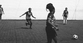 Female football team cheerfully playing in football