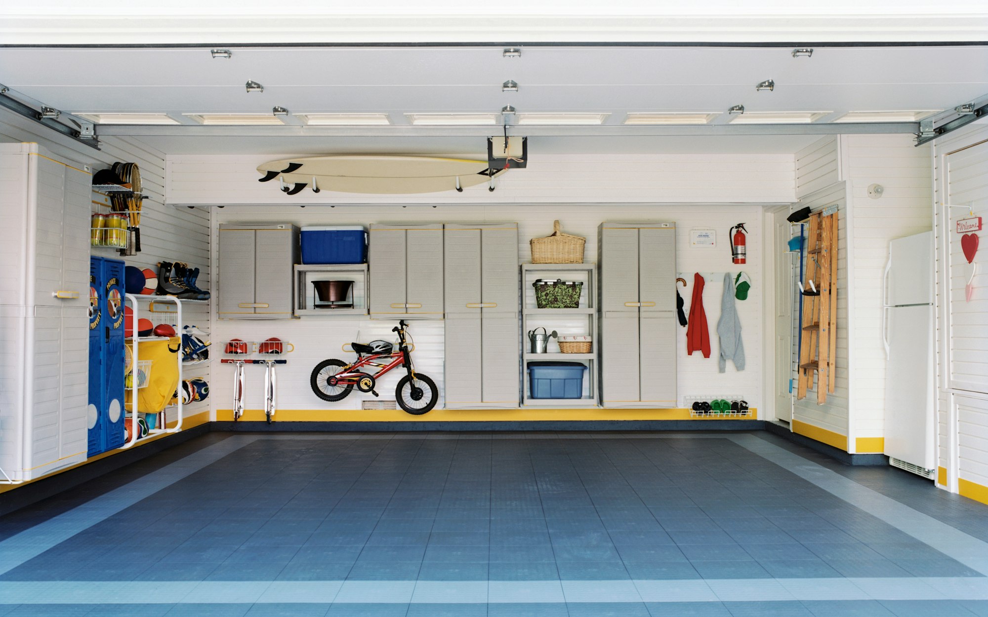 Surfboards and bicycles in empty garage