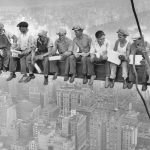 Men sitting on bar building scyscraper