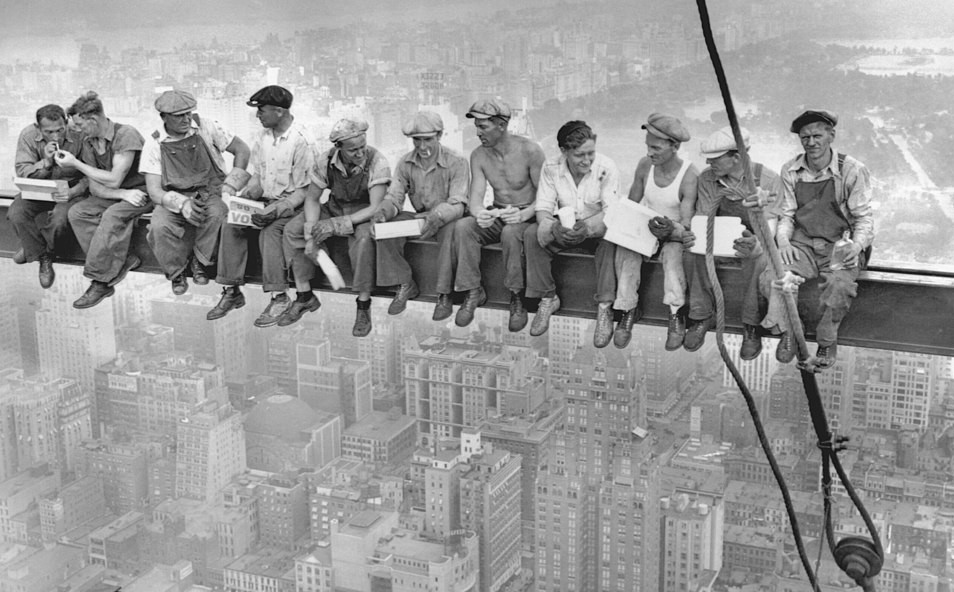 Men sitting on bar building scyscraper