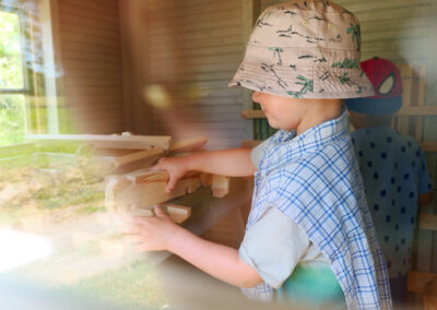 A young boy playing with wooden blocks