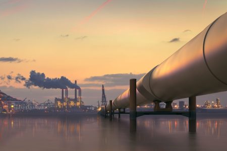 oil-pipeline-in-industrial-district-with-factories-at-dusk-517340891-5ac2f4803128340037663a21
