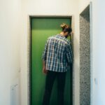 Young man locking home front door