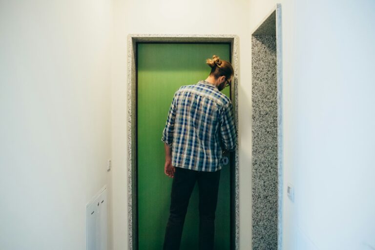 Young man locking home front door