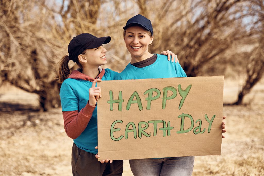 Earth Day 2024, a woman and a kid holding a Happy Earth Day Sign