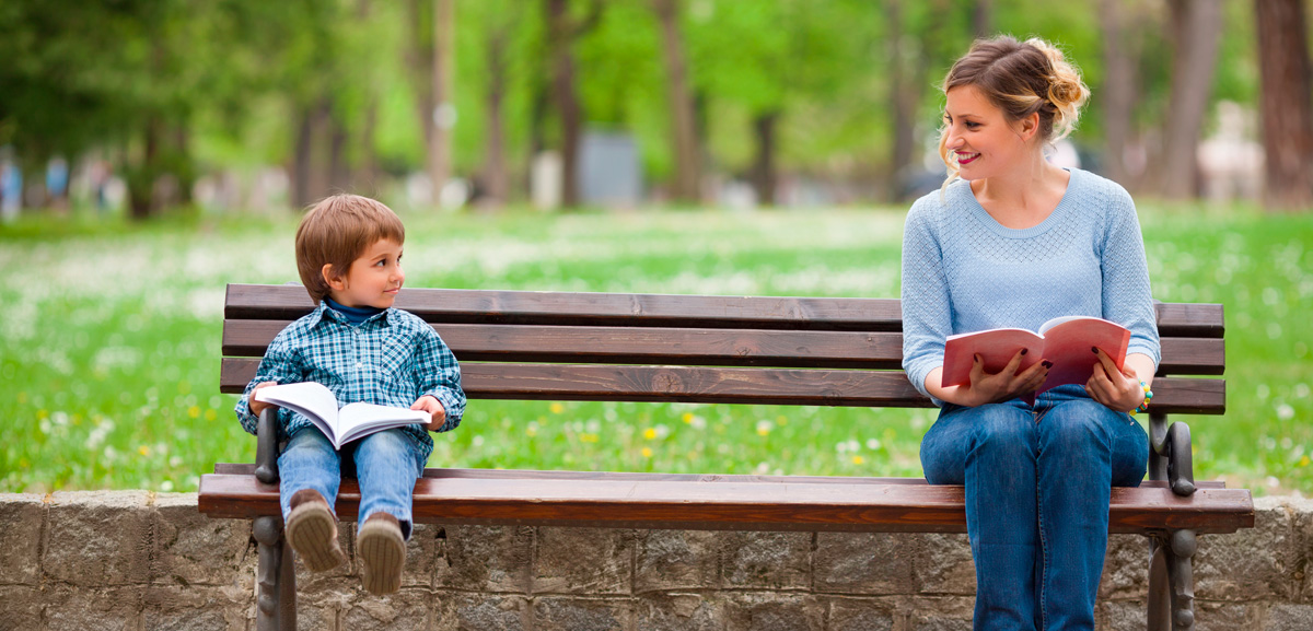 Woman and child on a bench with books