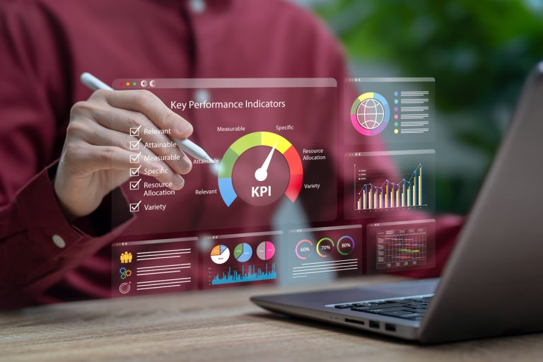 Business professional interacting with KPI dashboard showing performance metrics, analytics charts, and data visualization for nearshore team communication and transparency