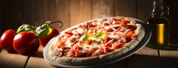 Pizza with bacon on the wooden table