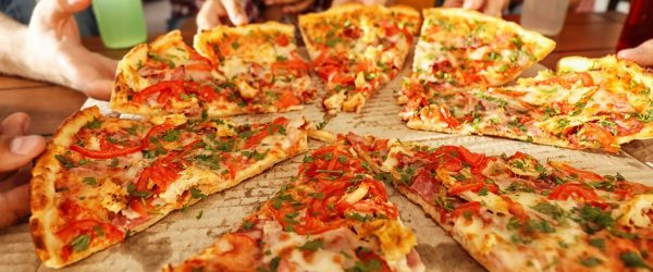 Group of friends eating pizza