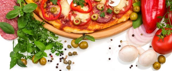 Pizza with mushrooms, sausage and vegetables on a white background.