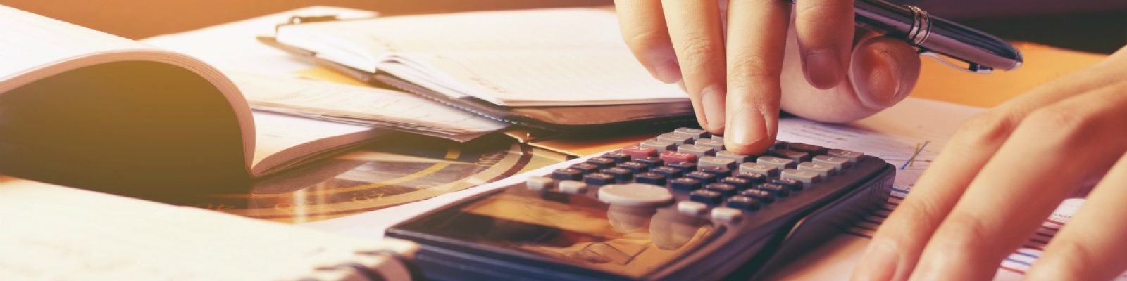 Woman using calculator with doing finance at home office.