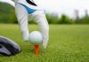 Hand putting golf ball on tee in golf course Getty Images/iStockphoto